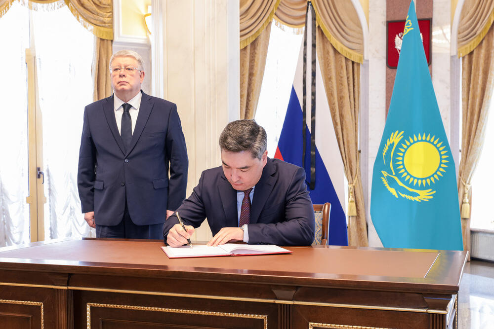 Olzhas Bektenov leaving note in condolence book at Russian Embassy in Astana